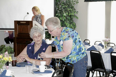 2012 Banquet Class of 1962
Janet Moore shows pictures to Christine Bingham Hammon, `62
